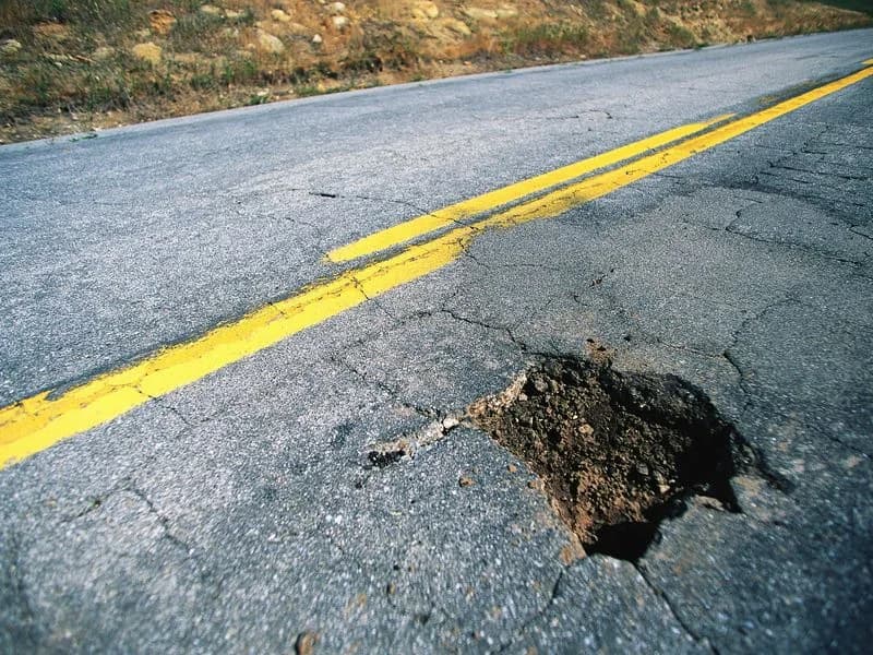 Pothole in an asphalt roadway before repair